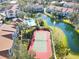 Community tennis court next to pond and landscaping at 850 S Tamiami Trl # 724, Sarasota, FL 34236