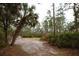 Wooded backyard with a clear and level area suitable for outdoor activities at 8570 Tropicaire Blvd, North Port, FL 34291