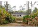 View of the home exterior surrounded by lush vegetation and natural landscaping at 8570 Tropicaire Blvd, North Port, FL 34291