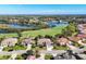 Beautiful aerial view of homes near golf course and lake in a well landscaped community at 8727 Grey Oaks Ave, Sarasota, FL 34238