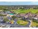 Aerial view of community clubhouse, parking and golf course at 8727 Grey Oaks Ave, Sarasota, FL 34238