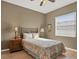 Neutral bedroom with window, side tables, and metal-frame bed at 8727 Grey Oaks Ave, Sarasota, FL 34238