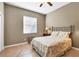 Bedroom with earth-tone walls, window with blinds, and floral bedspread at 8727 Grey Oaks Ave, Sarasota, FL 34238