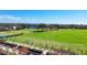 An elevated view of people enjoying the community golf course driving range at 8727 Grey Oaks Ave, Sarasota, FL 34238