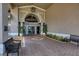 Welcoming entrance to Stoneybrook with brick pathway, benches, and well-manicured landscaping at 8727 Grey Oaks Ave, Sarasota, FL 34238