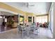 Outdoor lanai featuring tile floor, ceiling fan and outdoor dining table and chairs at 8727 Grey Oaks Ave, Sarasota, FL 34238