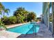 Refreshing private pool surrounded by lush tropical landscaping, ideal for relaxation and entertainment at 8727 Grey Oaks Ave, Sarasota, FL 34238