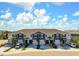 An aerial view of the townhome exteriors showcases landscaping, private driveways, and ample parking at 8737 Daydream St, Sarasota, FL 34238