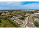 Community aerial view showcasing manicured landscaping, townhomes, and peaceful water features at 8737 Daydream St, Sarasota, FL 34238