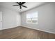 Bedroom with a window offering natural light, hardwood floors, and closet at 8737 Daydream St, Sarasota, FL 34238