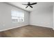 Bright bedroom with hardwood floors, a ceiling fan, and a large window at 8737 Daydream St, Sarasota, FL 34238