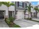 Exterior of the townhome with garage, stone accents, landscaping, and private driveway at 8737 Daydream St, Sarasota, FL 34238