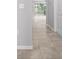 Light and airy hallway featuring tile flooring leading to a bright window at 8737 Daydream St, Sarasota, FL 34238