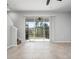 Spacious living room features tile floors and a large sliding glass door to outside at 8737 Daydream St, Sarasota, FL 34238