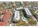 Aerial view of condo complex with pool and tennis courts at 8767 Midnight Pass Rd # 505F, Sarasota, FL 34242