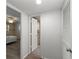 Hallway with wood-look flooring, linen closet, and bedroom access at 8767 Midnight Pass Rd # 505F, Sarasota, FL 34242