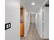 Long hallway with wood-look floors and built-in shelving at 8767 Midnight Pass Rd # 505F, Sarasota, FL 34242