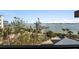 Stunning water view with a dock and lush landscaping at 8767 Midnight Pass Rd # 505F, Sarasota, FL 34242