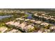 Aerial view of a beautiful neighborhood with lakes and mature landscaping at 8849 Etera Dr, Sarasota, FL 34238