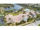 An aerial view shows the clubhouse, pool, lake with fountain, and community amenities at 8849 Etera Dr, Sarasota, FL 34238