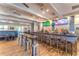 Spacious bar area with multiple stools, televisions, and ample counter space for serving beverages at 8849 Etera Dr, Sarasota, FL 34238