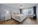 Bright bedroom with a queen bed, wood floors, neutral wall paint, and natural light from the windows at 8849 Etera Dr, Sarasota, FL 34238