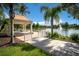 Charming gazebo overlooking a serene lake with a fountain, perfect for relaxation and gatherings at 8849 Etera Dr, Sarasota, FL 34238