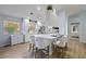 Bright kitchen featuring white cabinets, an island with bar seating, stainless steel appliances and wood flooring at 8849 Etera Dr, Sarasota, FL 34238