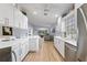 Bright kitchen featuring white cabinets, stainless steel appliances and wood flooring at 8849 Etera Dr, Sarasota, FL 34238