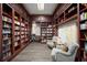 Cozy library with floor to ceiling bookshelves, comfortable seating, and decorative maps at 8849 Etera Dr, Sarasota, FL 34238