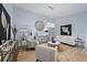 Elegant living room with light blue walls, wood floors, modern furniture, and stylish decor at 8849 Etera Dr, Sarasota, FL 34238