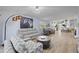 Cozy living room featuring a neutral color scheme, wood floors, comfortable seating, and an open layout at 8849 Etera Dr, Sarasota, FL 34238