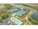 Overhead view of numerous tennis courts next to community pool and parking at 8849 Etera Dr, Sarasota, FL 34238