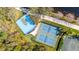 Overhead view of tennis and basketball courts in community with walkway and foliage at 8849 Etera Dr, Sarasota, FL 34238