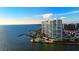 Aerial view of high rise waterfront condo complex with resort style pool and boat docks at 888 Blvd Of The Arts # 1608, Sarasota, FL 34236