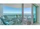 Relaxing balcony seating area features a small table and chairs with views of the bay at 888 Blvd Of The Arts # 1608, Sarasota, FL 34236