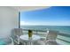 Relaxing balcony seating area features a small table and chairs with endless bay views at 888 Blvd Of The Arts # 1608, Sarasota, FL 34236