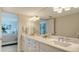 Bright bathroom features white cabinetry, quartz counters, double sinks, and stylish fixtures at 888 Blvd Of The Arts # 1608, Sarasota, FL 34236