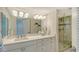 Bathroom with a large mirror, shower, vanity, and drawers at 888 Blvd Of The Arts # 1608, Sarasota, FL 34236