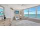 Sunny bedroom featuring two beds, tv, dresser, and view of the sea at 888 Blvd Of The Arts # 1608, Sarasota, FL 34236