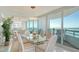 Bright dining room boasts a glass table, seating for six, and large windows with amazing water views at 888 Blvd Of The Arts # 1608, Sarasota, FL 34236