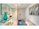 Inviting hallway with stylish decor, featuring a teal vase and a jellyfish rug with a bench at 888 Blvd Of The Arts # 1608, Sarasota, FL 34236