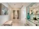 Hallway featuring a light-tone bench, artwork, glass shelf unit, and double frosted doors at 888 Blvd Of The Arts # 1608, Sarasota, FL 34236