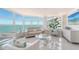 Bright living room with floor-to-ceiling windows offering panoramic water views with bright white furniture at 888 Blvd Of The Arts # 1608, Sarasota, FL 34236