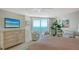 Inviting bedroom boasts a large window, a flat screen TV, and beach views at 888 Blvd Of The Arts # 1608, Sarasota, FL 34236