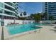 Outdoor swimming pool with lounge chairs and a view of a high-rise at 888 Blvd Of The Arts # 1608, Sarasota, FL 34236