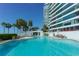 Swimming pool with lounge chairs and high rise building in the background at 888 Blvd Of The Arts # 1608, Sarasota, FL 34236