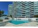 Outdoor swimming pool with lounge chairs and a view of a high-rise at 888 Blvd Of The Arts # 1608, Sarasota, FL 34236