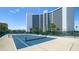 Tennis courts with view of a high rise building and palm trees at 888 Blvd Of The Arts # 1608, Sarasota, FL 34236