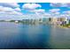 Expansive waterfront view showcasing a skyline of modern condominium buildings against a bright blue sky with scattered clouds at 888 Blvd Of The Arts # 1608, Sarasota, FL 34236